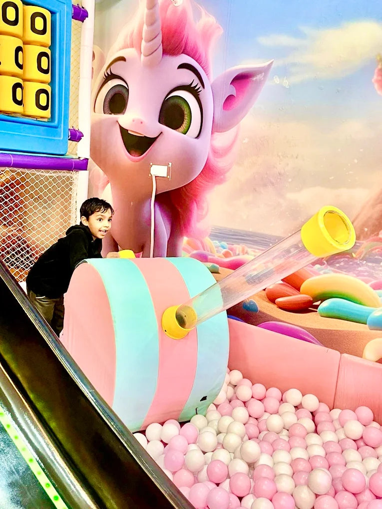 Inflatable unicorn with a ball pit in an indoor playground