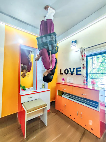A person is upside down in a room with furniture, appearing to walk on the ceiling.