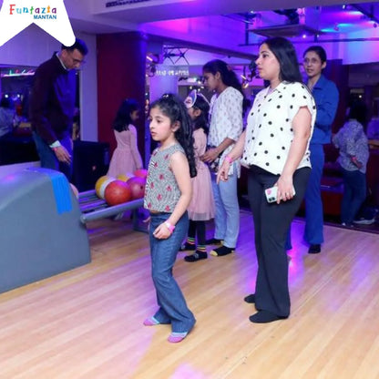 Children and adults at a bowling alley.