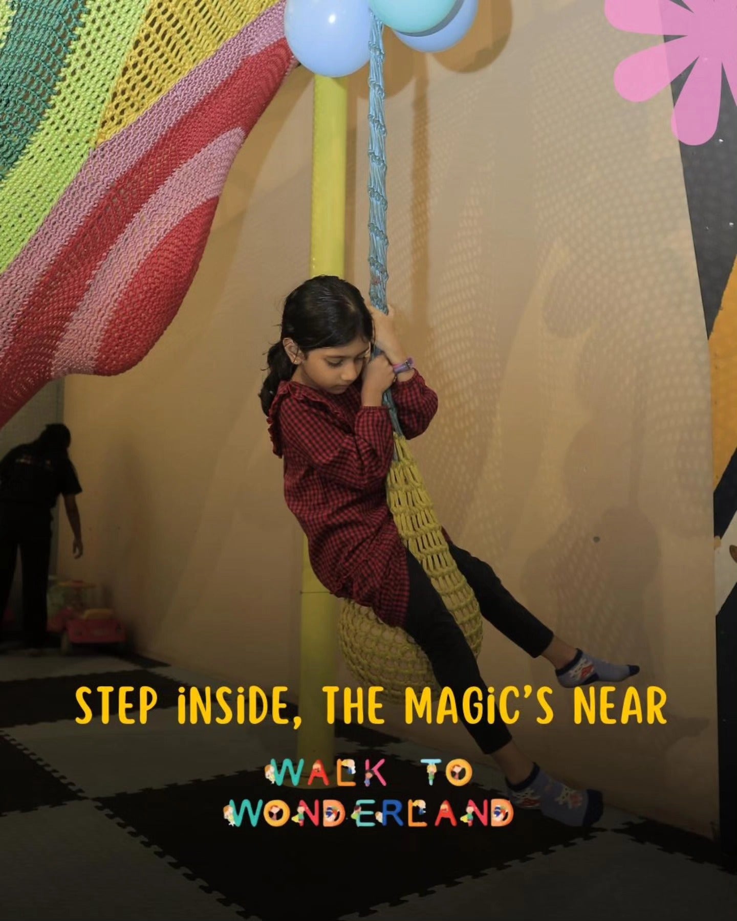 Young girl sitting on a colorful woven swing inside Walk to Wonderland Indoor Play Area Chhatarpur New Delhi
