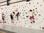 Group of children wall climbing for fun