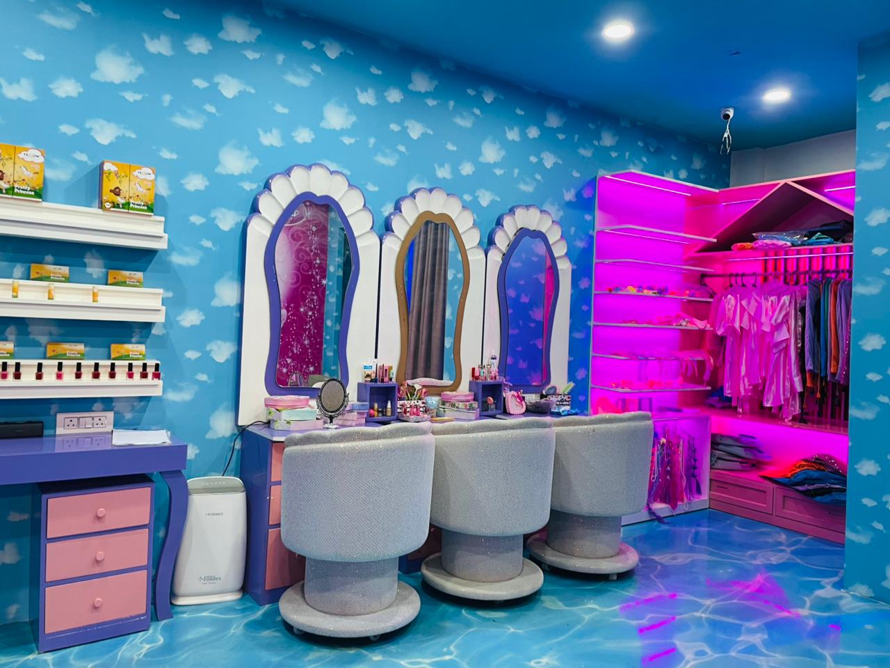 A whimsical room with a cloud-themed ceiling, vanity, and closet, likely for children.