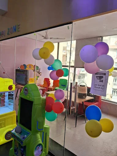 A brightly lit arcade with colorful balloons and children's games.