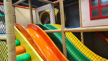 A colorful indoor playground with slides and tunnels for children.