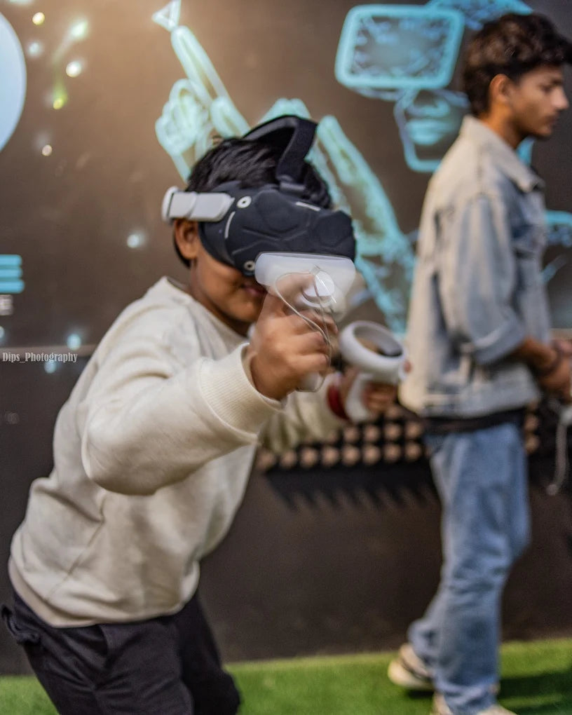 A young person plays a VR game while another person stands nearby.