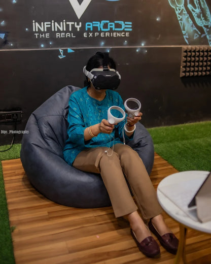 A person in a VR headset plays a game while sitting on a beanbag chair.