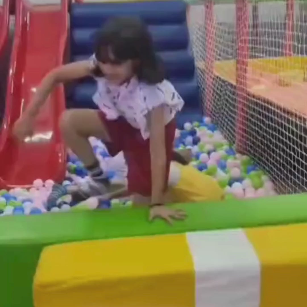 Kids enjoying fun activities at an indoor play area and arcade play zone with trampolines, wall climbing, slides, ball pool, arcade games, air hockey, foam pit, zip line, and horse carousel, offering joyful entertainment for children.