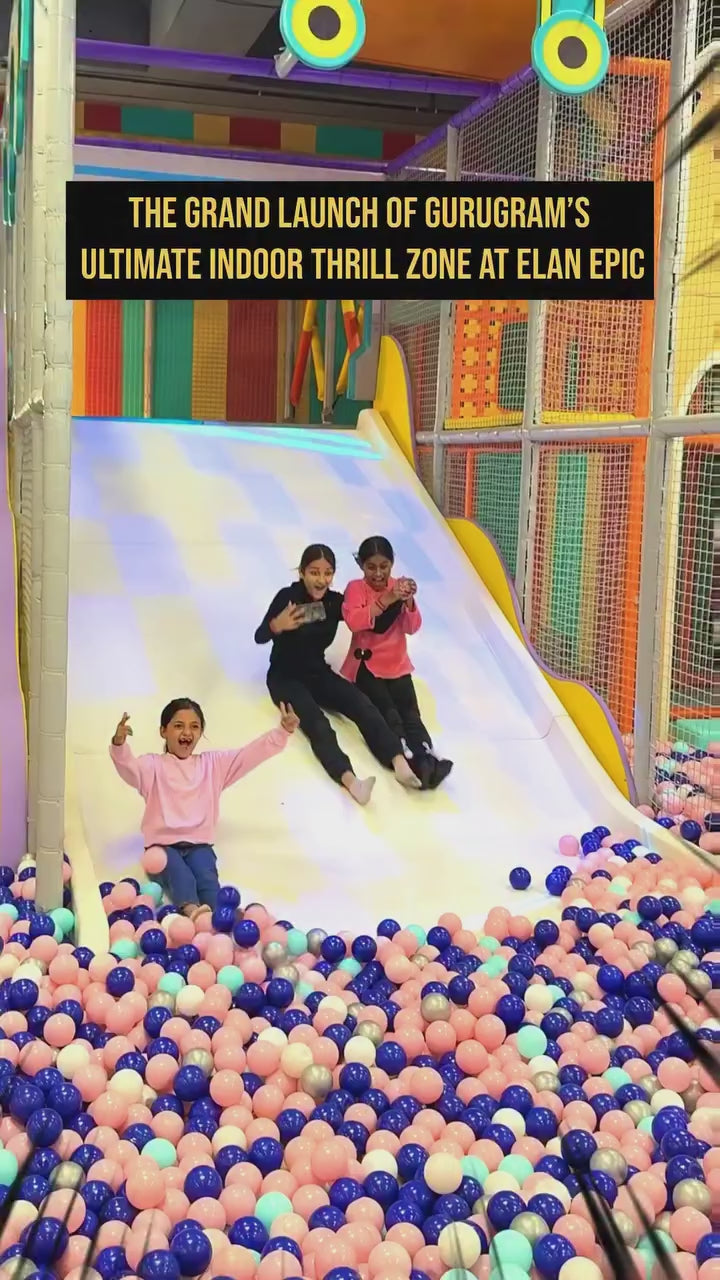 Children and adults enjoy a vibrant indoor thrill zone with ball pits, arcade games, bowling, and virtual reality experiences. The colorful, energetic environment is filled with laughter and excitement, featuring various attractions for all ages.