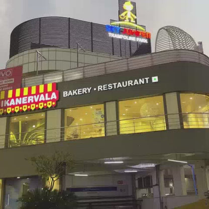 A trampoline park with colorful trampolines, foam pits, and a rock-climbing wall offers fun for all ages. The vibrant, energetic atmosphere is perfect for active play and exciting adventures.