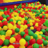 Children of various ages enjoy a vibrant indoor play area filled with colorful balls, slides, and climbing structures. The "Toddler Zone" caters to ages 1-3, while the "Junior Zone" is for ages 3-14, offering a safe and exciting environment for play and adventure. The atmosphere is lively and fun, with kids actively engaged in activities like sliding, swinging, and exploring.