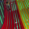 A young child gleefully navigates a vibrant indoor playground filled with colorful slides, ball pits, and climbing structures. The atmosphere is energetic and playful, with bright lights and soft surfaces creating a safe and exciting environment for children to explore and have fun.
