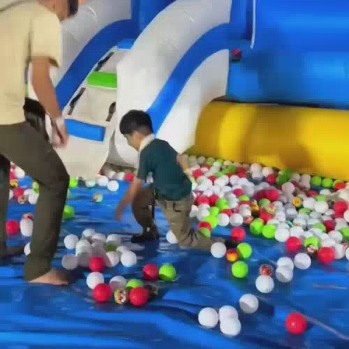 Children and adults enjoy a vibrant inflatable park with slides, ball pits, and climbing walls. A costumed character interacts with guests, adding to the festive atmosphere. The park features various attractions, including a "ZooRee" section with reptiles and other creatures.
