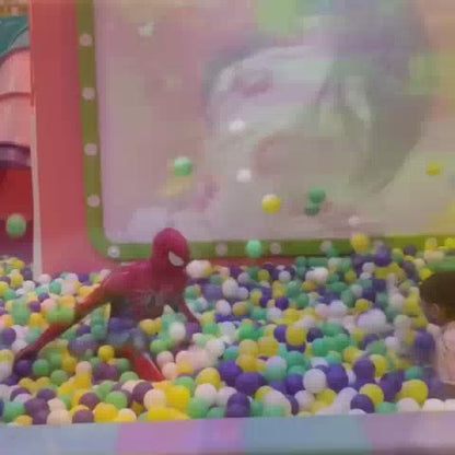 Children of various ages enjoy a vibrant indoor playground filled with ball pits, swings, and interactive games. The atmosphere is lively and playful, with colorful equipment and soft surfaces creating a safe and engaging environment for fun.