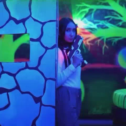 Teens and adults enjoying an indoor laser tag zone with action-packed gameplay and immersive entertainment.