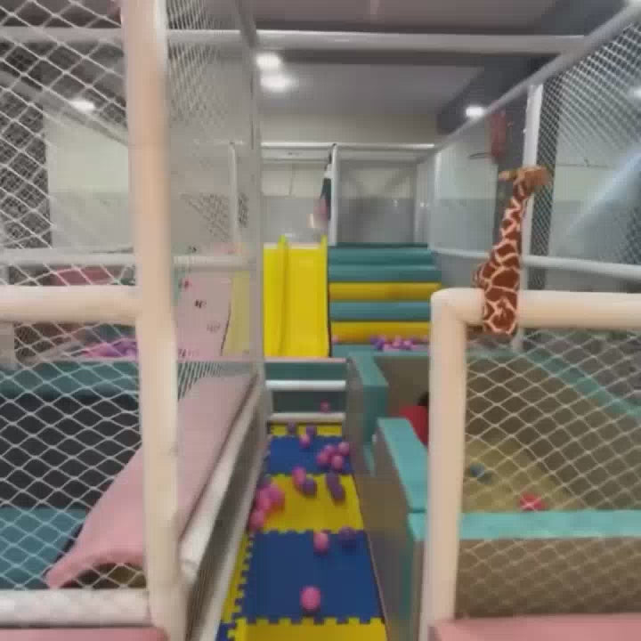 This video showcases a vibrant indoor playground filled with children of various ages enjoying a variety of attractions. The environment is colorful and stimulating, featuring ball pits, slides, climbing walls, and interactive play areas. The atmosphere appears lively and fun, with kids actively engaged in play and exploration.