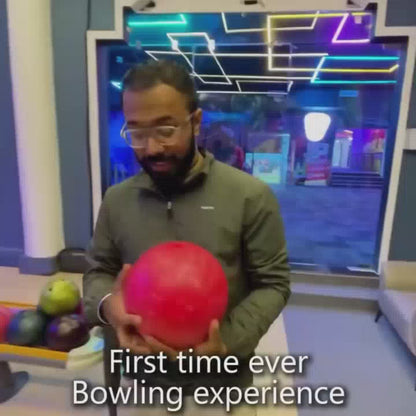 A vibrant indoor entertainment center offers a variety of activities for all ages. The setting is filled with neon lights, arcade games, bowling lanes, and a soft play area for younger children. Thrill-seekers can enjoy VR experiences, bumper cars, a trampoline park, and outdoor adventures like a giant swing and zipline.