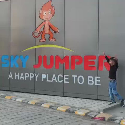 Children enjoy a day of fun at an indoor amusement park, bouncing on trampolines, sliding down colorful chutes, and playing laser tag. The vibrant environment is filled with bright colors and exciting attractions, creating a lively and energetic atmosphere.