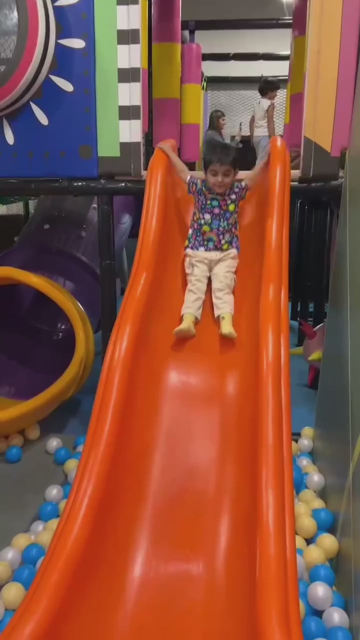 Kids enjoying trampoline, slides, and ball pool fun at an indoor play area, featuring a safe kids zone and exciting arcade play zone activities.