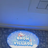 Children and adults enjoy a snowy wonderland at Snow Village, engaging in activities like sledding, playing in the snow, and posing for photos. The indoor snow park features playful decorations, including a ski lift and cartoon animals, creating a fun and festive atmosphere.