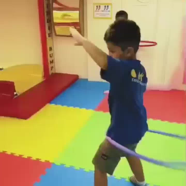 Children of various ages enjoy a vibrant indoor playground filled with colorful ball pits, slides, and climbing structures. The atmosphere is lively and playful as kids engage in climbing, sliding, and building with soft blocks. The environment is designed for fun and active play, featuring bright colors and engaging equipment.