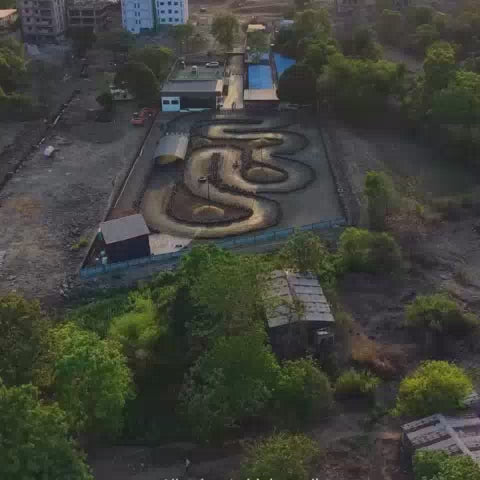 An aerial view shows a go-kart track with several karts racing. Later, people are seen playing pickleball on an outdoor court. The atmosphere is lively and fun, with a mix of activities for different age groups.