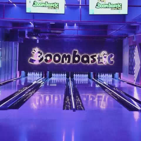 This video showcases a vibrant indoor amusement park filled with children of various ages enjoying a range of exciting activities. The setting is a colorful and energetic environment featuring bowling lanes, arcade games, inflatable slides, a ball pit, and a zip line. The atmosphere is one of pure fun and excitement, with laughter and joyful screams filling the air as kids engage with the diverse attractions.