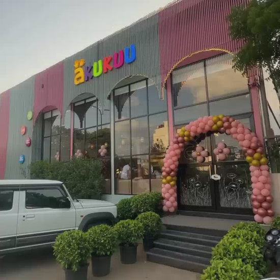 Children of various ages enjoy a vibrant indoor playground filled with colorful ball pits, slides, trampolines, and climbing structures. The atmosphere is lively and playful, with kids actively engaged in fun activities.
