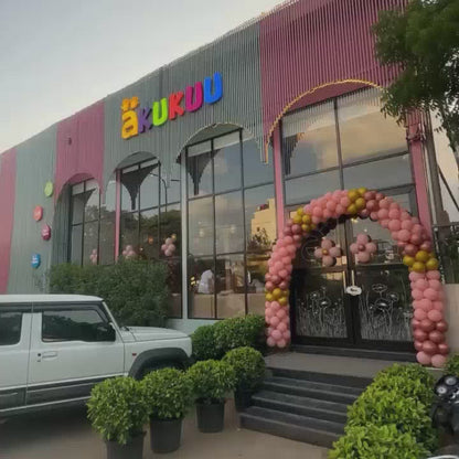Children of various ages enjoy a vibrant indoor playground filled with colorful ball pits, slides, trampolines, and climbing structures. The atmosphere is lively and playful, with kids actively engaged in fun activities.