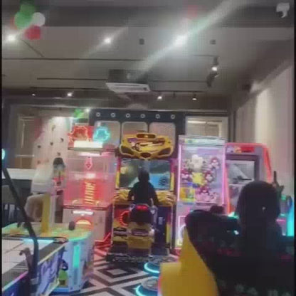 Children of various ages enjoy a vibrant indoor play area filled with ball pits, slides, and arcade games. The atmosphere is lively and engaging, with kids actively participating in different attractions. The setting features colorful decorations, soft play structures, and interactive gaming machines, creating a fun-filled environment for young visitors.