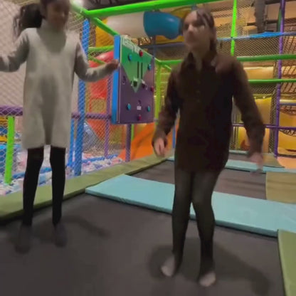 Children having fun in an indoor play area with slides and soft play zones, engaging activities for kids in a safe environment.