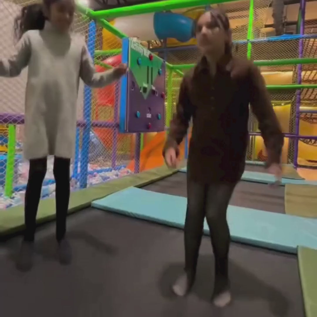 Children having fun in an indoor play area with slides and soft play zones, engaging activities for kids in a safe environment.