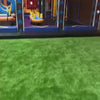 This video showcases a vibrant indoor inflatable park filled with colorful slides, obstacle courses, and climbing structures. The environment is designed for active fun, with a soft, green turf floor and bright, energetic decor. It appears to be a place for children and families to enjoy a day of play and excitement.