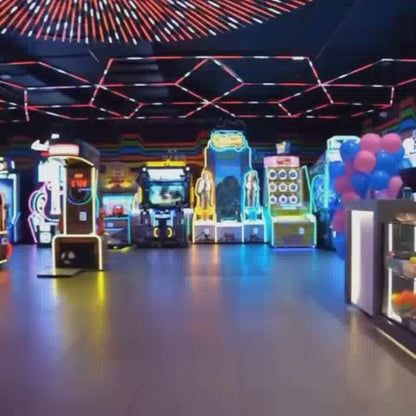 A vibrant arcade buzzes with activity, featuring air hockey, VR simulators, and claw machines. Young adults and children alike enjoy the energetic atmosphere, surrounded by colorful lights and exciting games. The setting is a modern entertainment center, perfect for a fun-filled outing.