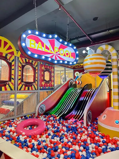 Kids enjoying fun activities at an indoor play area with slides, ball pool, and safe play zones, offering joyful entertainment for children.