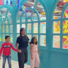 A vibrant indoor play area with colorful slides, ball pits, and climbing walls provides endless fun for young children. The atmosphere is lively and energetic, with kids of various ages actively engaged in play. The setting is designed to be visually stimulating and safe for children's activities.