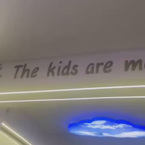 A young girl enjoys a vibrant indoor play area, sliding down a red spiral slide into a ball pit, then climbing a colorful wall. Later, she plays arcade games, her parents watching and participating. The atmosphere is lively and fun, with bright lights and engaging attractions.