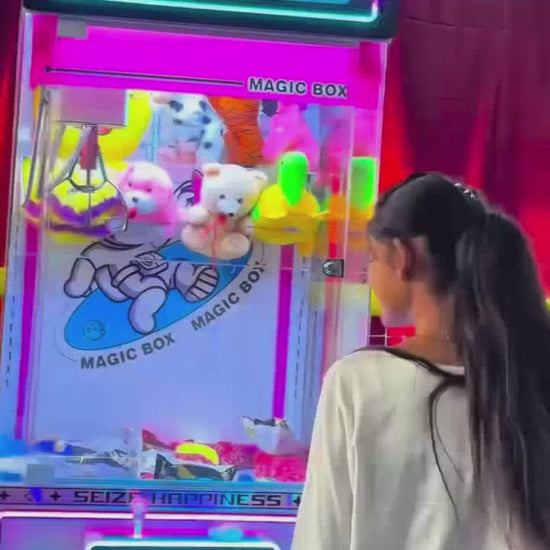 Children of various ages enjoy a vibrant indoor play area filled with colorful balls, slides, and a claw machine. A bouncy castle with playful characters and a "Welcome" arch adds to the festive atmosphere. The scene captures the joy and excitement of kids engaging in active play.