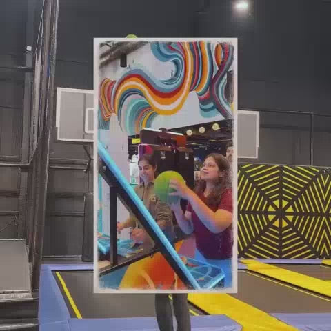 This video showcases a vibrant indoor amusement park filled with various attractions. Young children and teenagers are seen enjoying thrilling rides like a drop tower and a VR simulator, as well as engaging in activities like laser tag and a foam pit. The atmosphere is energetic and fun, with colorful decorations and exciting games.