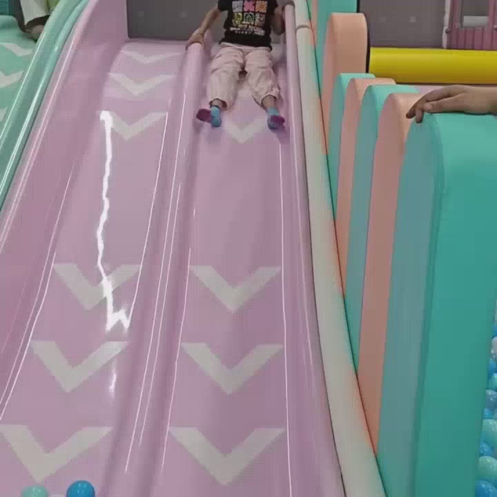 A young girl enjoys a vibrant indoor playground filled with colorful ball pits, slides, and interactive musical instruments. She slides into a ball pit, plays a floor piano, and pretends to be a doctor and a construction worker. The atmosphere is playful and engaging, with other children and adults present.
