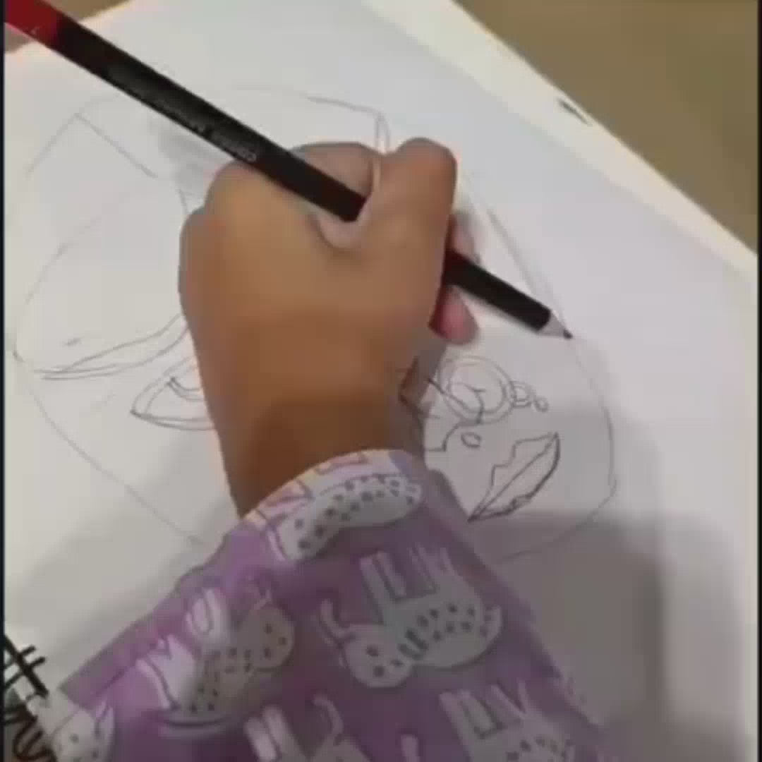 A person is drawing a portrait of a woman with yellow skin and red lips. The person is using a paintbrush and watercolors. The drawing is on a white piece of paper. The person is wearing a purple shirt with a pattern of elephants. The person is also drawing a man with a bow and arrow. The man is blue and wearing orange pants. The drawing is on a white piece of paper. The person is using a pencil.