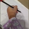 A person is drawing a portrait of a woman with yellow skin and red lips. The person is using a paintbrush and watercolors. The drawing is on a white piece of paper. The person is wearing a purple shirt with a pattern of elephants. The person is also drawing a man with a bow and arrow. The man is blue and wearing orange pants. The drawing is on a white piece of paper. The person is using a pencil.