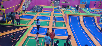 Children playing in a colorful indoor playground with various activities and slides.